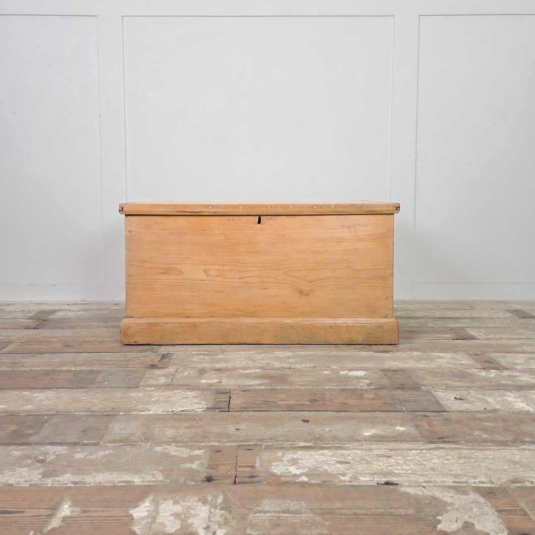 A solid Victorian pine storage chest with lift-up lid and internal drawers, finished in clear wax to highlight the pine grain. A rustic antique blanket box or farmhouse trunk offering versatile and durable household storage.