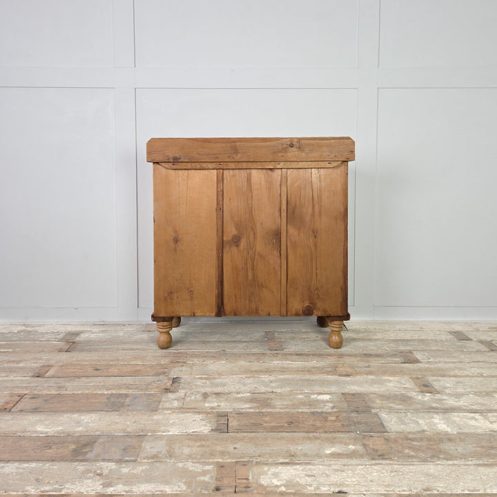 A late 19th-century Victorian pine chest of drawers with a two-over-two layout, original wooden knobs and traditional bun feet, sealed in clear wax to protect its warm patina. A beautiful antique storage piece that suits rustic, farmhouse and country-style interiors.