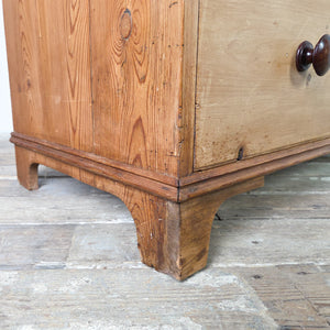 A Victorian farmhouse style pine chest of drawers dating to the 19th century, featuring four drawers in a two short over two long layout. The chest has turned wooden knobs, a moulded edge to the top, and decorative shaped bracket feet.
