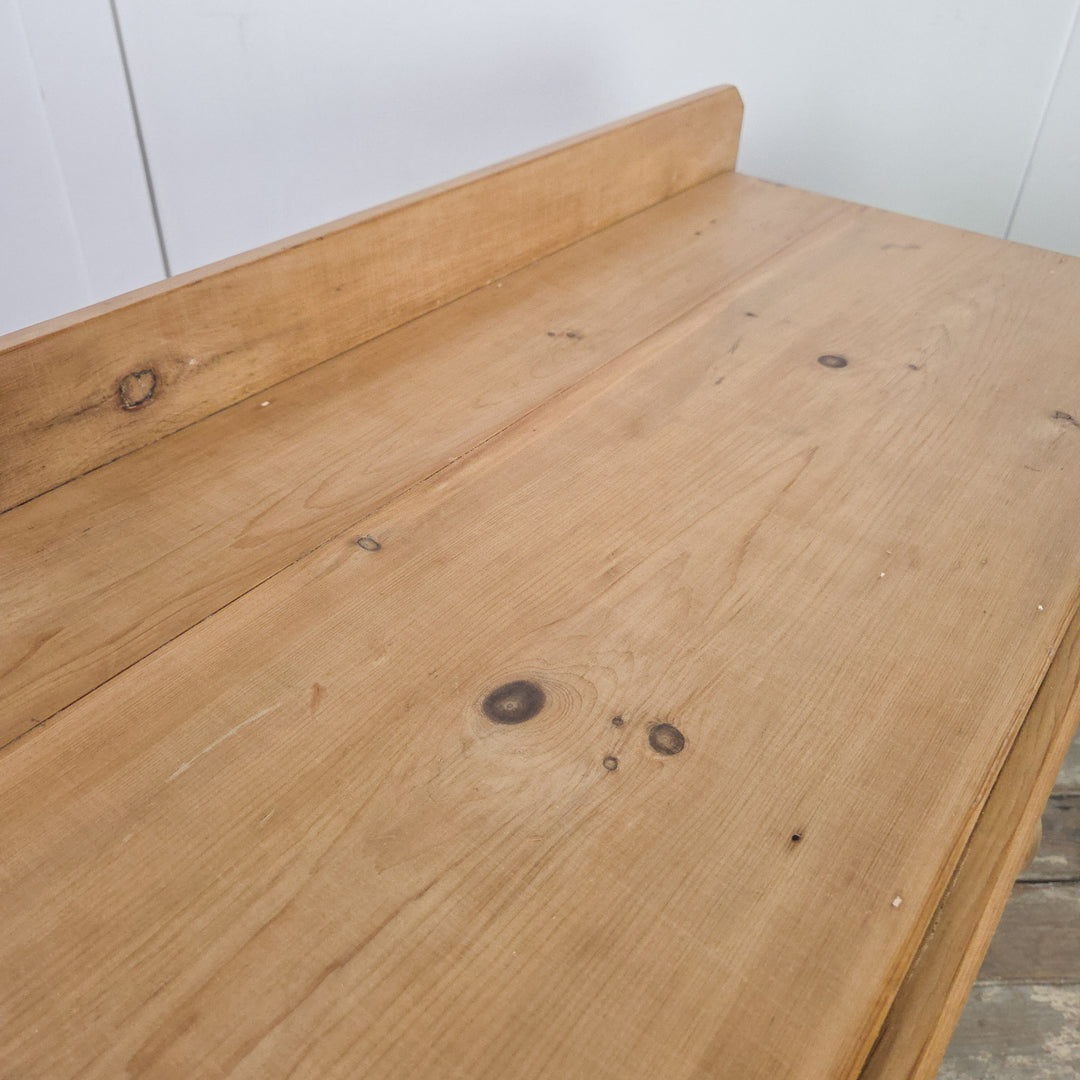 A 19th-century Victorian pine chest of drawers featuring bun feet and a two-over-two arrangement, finished in clear wax for protection and ideal as a functional antique storage piece or bedroom dresser.
