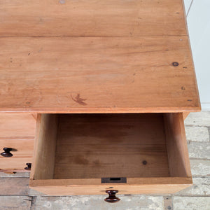 A Victorian pine chest of drawers dating to the 19th century, with four drawers graduating in depth and arranged in a two short over two long layout. The chest features turned wooden knobs, a moulded top edge, and shaped bracket feet.

