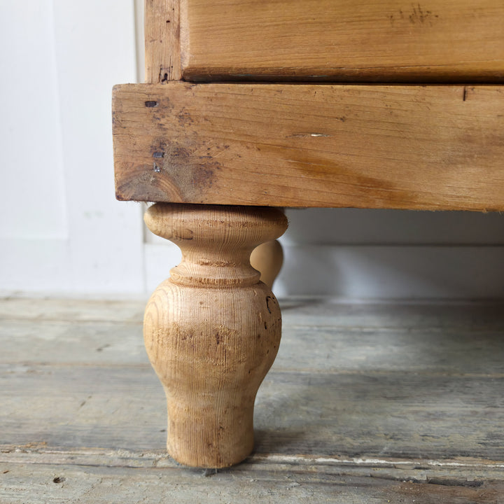 An antique pine chest with four drawers and gallery back, finished in warm tones, for versatile use across rooms