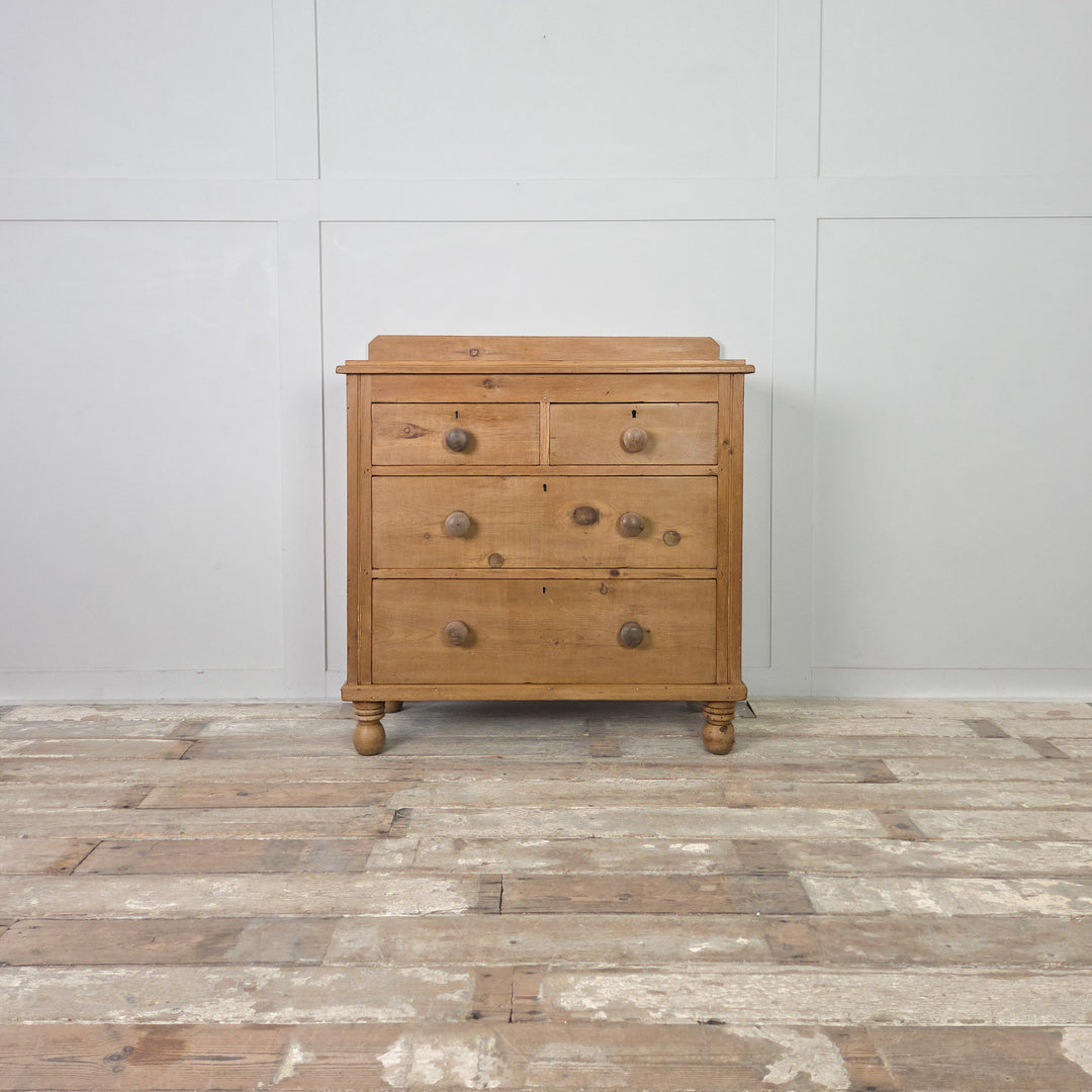 A 19th-century Victorian pine sideboard or chest of drawers with a clear waxed patina and traditional bun feet, offering four drawers and a simple, functional design typical of the period.