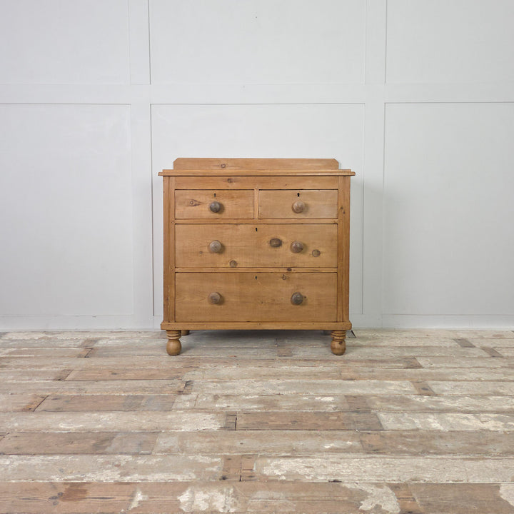 A 19th-century Victorian pine sideboard or chest of drawers with a clear waxed patina and traditional bun feet, offering four drawers and a simple, functional design typical of the period.