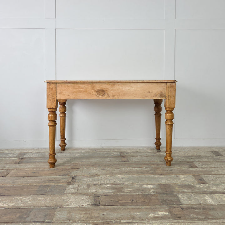 The 19th century pine console table, designed with a plain apron, turned legs, and practical twin drawers. A wax finish enhances the wood’s honey tones and provides protection for daily use.

