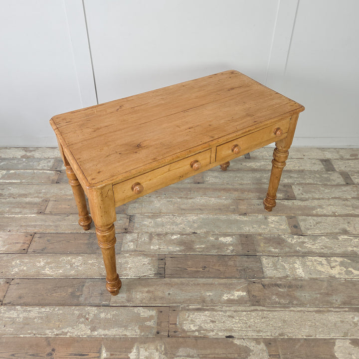 The Victorian pine table with decorative turned legs and neat, compact proportions, ideal for use as a rustic desk, hallway console, or dressing table in period or modern interior settings.


