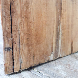 Victorian antique pine cupboard with twin panelled doors, brass knob and escutcheon, and four internal fixed shelves visible inside.
