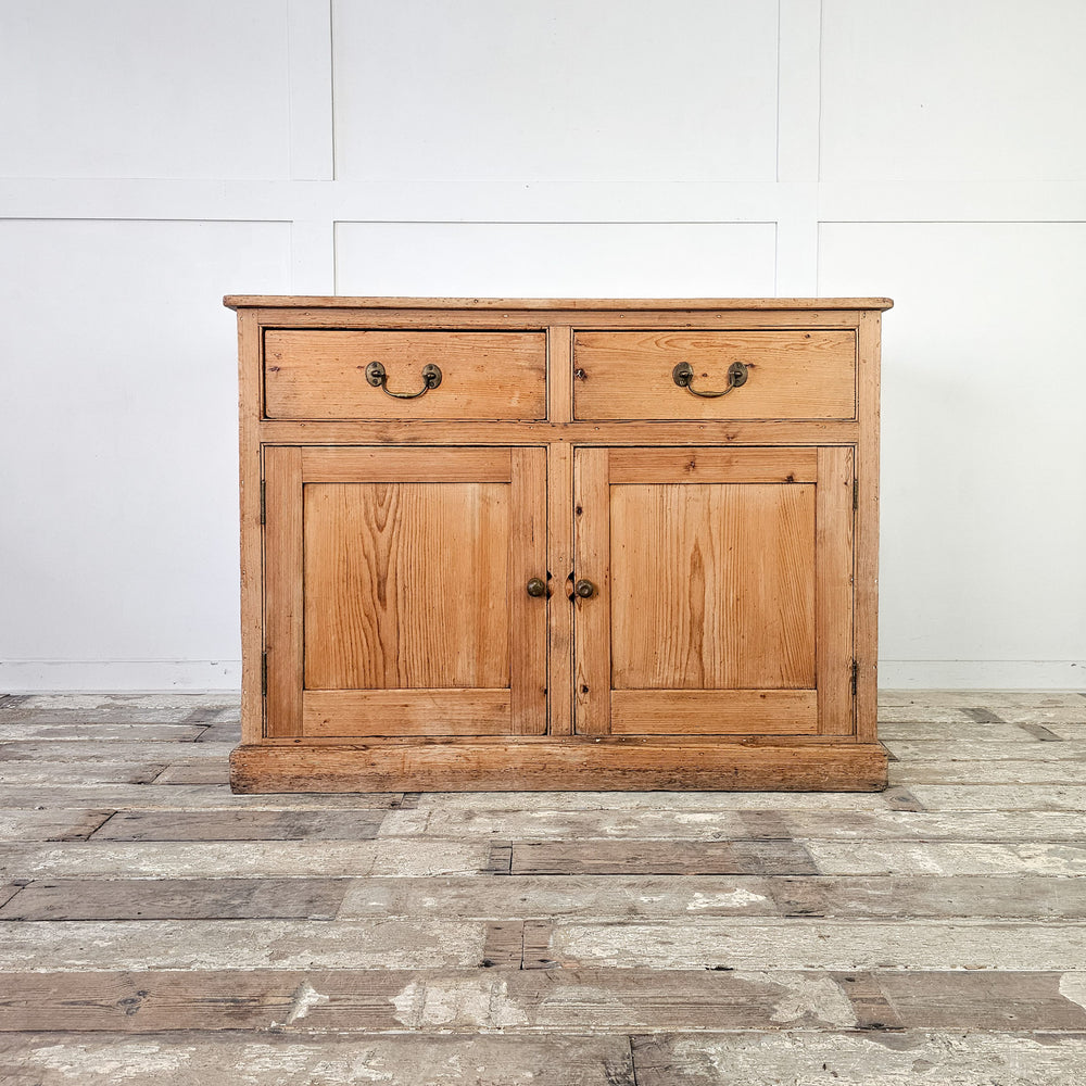 Rustic pine cupboard with internal shelf and brass hardware.