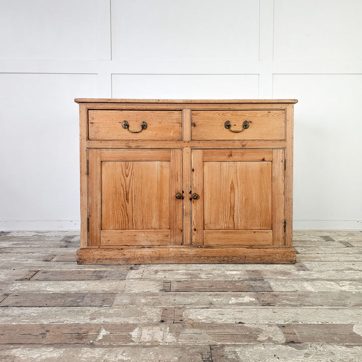 Rustic pine cupboard with internal shelf and brass hardware.