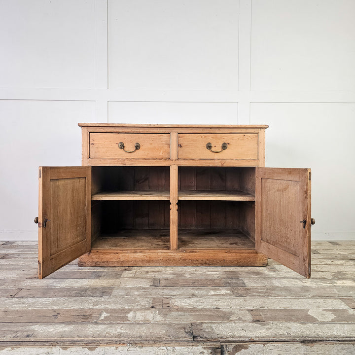 Vintage pine storage unit with two drawers and cupboard doors.