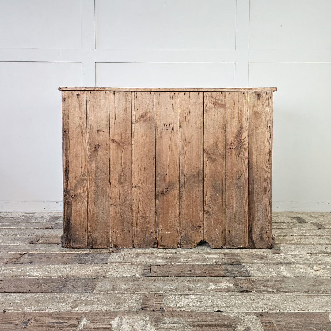 Pine storage cupboard with two upper drawers and lower cabinet.