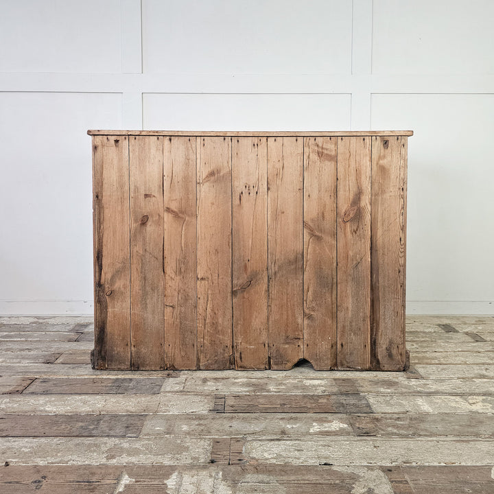 Pine storage cupboard with two upper drawers and lower cabinet.