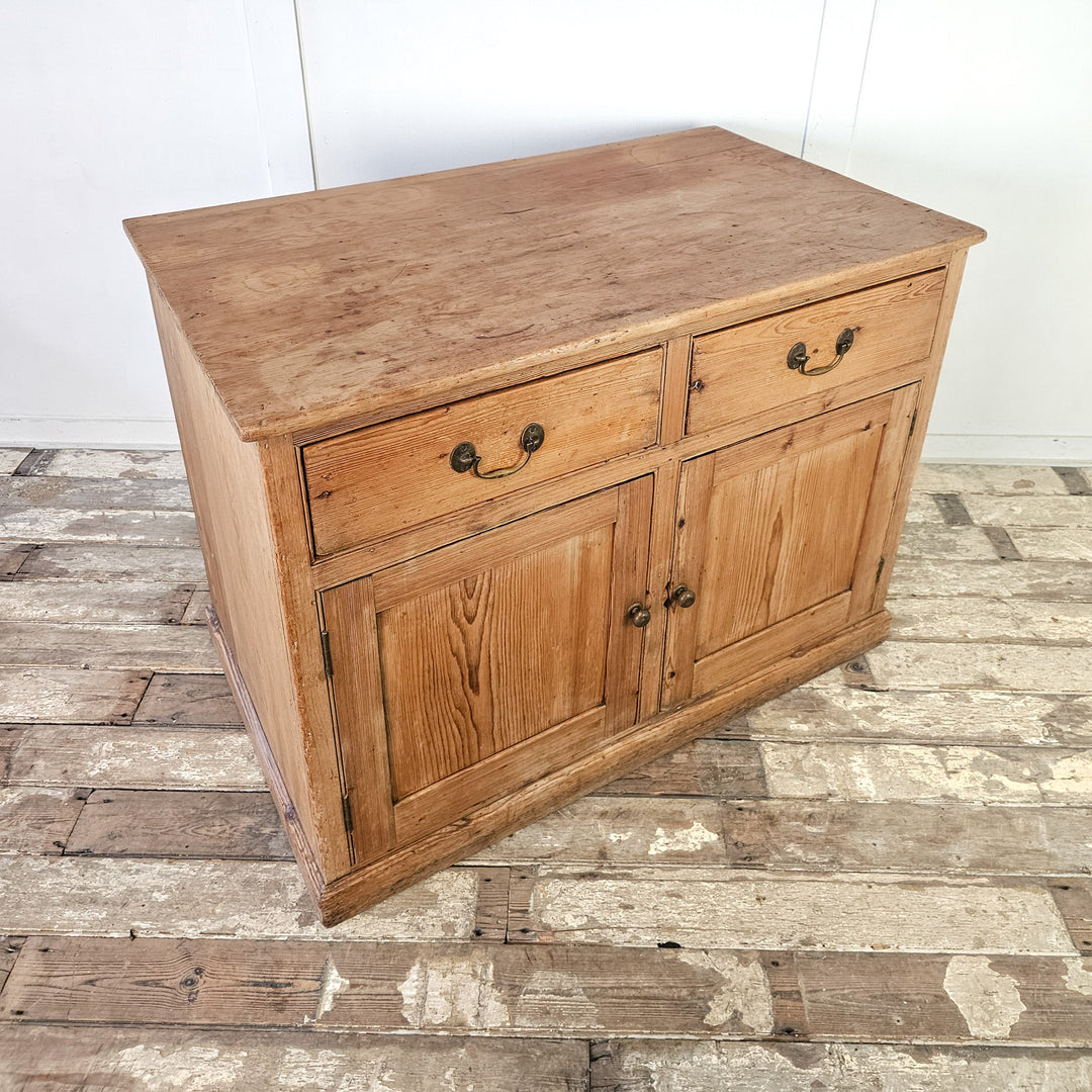Farmhouse-style pine cupboard with versatile storage options.
