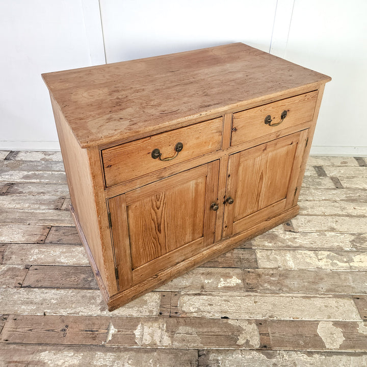 Farmhouse-style pine cupboard with versatile storage options.