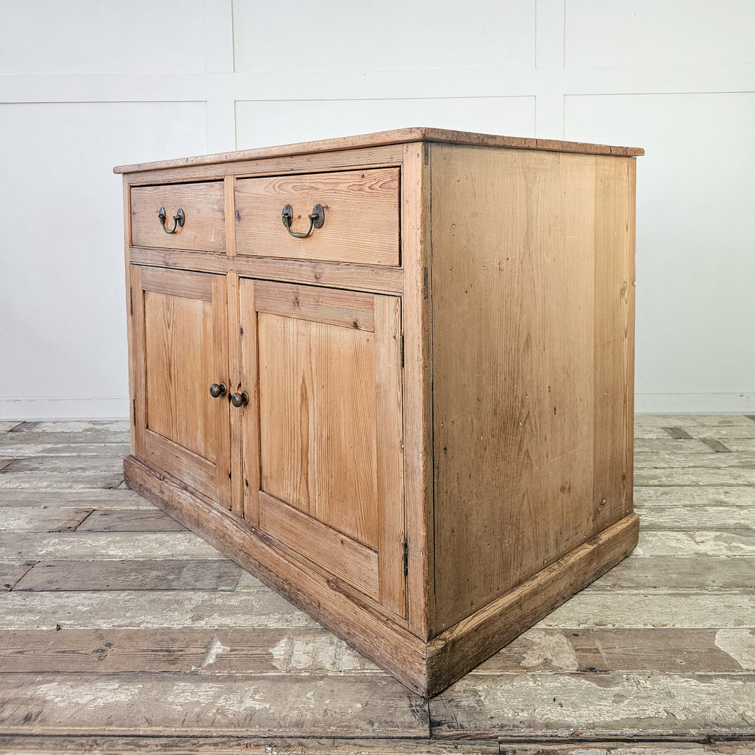 Pine media storage unit with traditional brass drawer pulls.