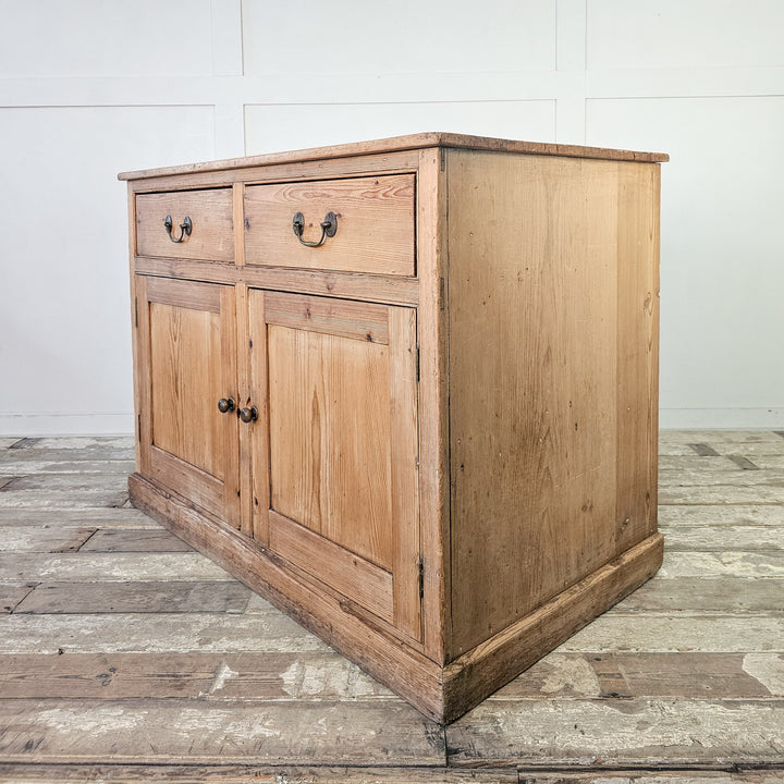 Pine media storage unit with traditional brass drawer pulls.