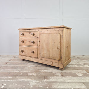 Victorian pine sideboard with three drawers, a panelled cupboard, and a light, scrubbed wood finish.
