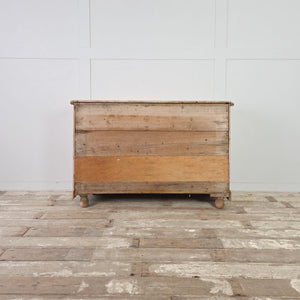 Rustic pine storage unit with three graduated drawers and a panelled cupboard on a solid pine base.
