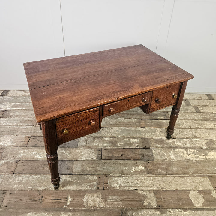 Late 19th century pine table with shaped apron, deep surface and classic farmhouse drawer layout
