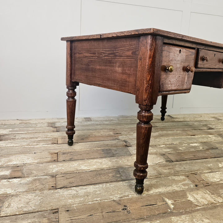 Pine farmhouse table with three working drawers, two-plank top and traditional base with castors