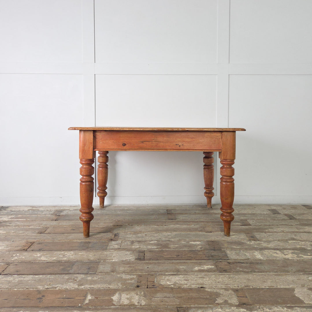Victorian pine farmhouse table with mellow wax finish, drawer storage and turned leg design, perfect for use as a rustic kitchen table, casual dining piece or small desk.
