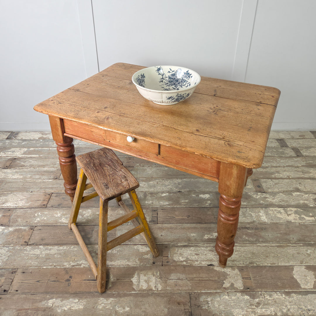 Victorian farmhouse table in stripped pine with chunky turned legs and traditional proportions, seating four comfortably in smaller dining rooms or farmhouse kitchens.
