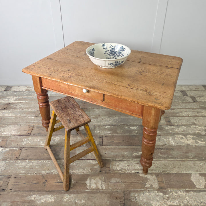 Victorian farmhouse table in stripped pine with chunky turned legs and traditional proportions, seating four comfortably in smaller dining rooms or farmhouse kitchens.
