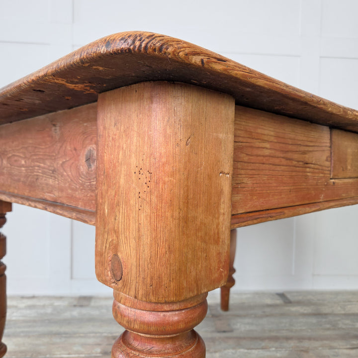 Sealed antique pine table with a scrubbed top and characterful marks, perfect for daily use as a four-seater dining table or small prep table in a Victorian or country-style home.
