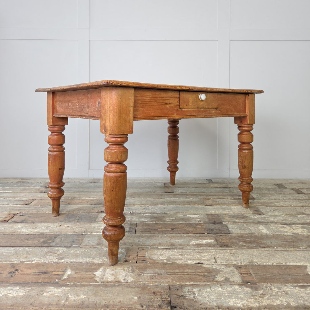 Victorian rustic kitchen table in solid pine with functional drawer and waxed surface, suitable for relaxed dining, meal prep, or use as a writing table in a study.
