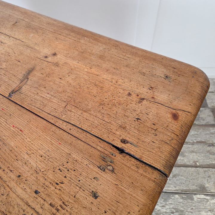 Detail of turned pine leg base on an antique Victorian farmhouse table, highlighting its solid construction and character-rich finish in stripped pine wax.

