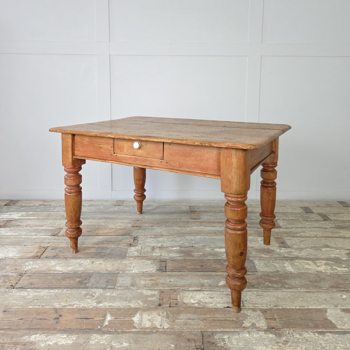 Rustic antique pine table with single frieze drawer, ideal as a small dining table or prep surface, with characterful wear and sealed wax finish highlighting the natural grain.
