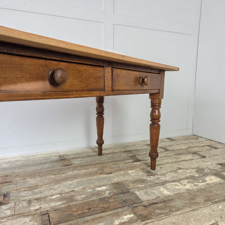 Antique farmhouse table, Victorian pine, functional drawers, period details, and solid joinery, blending seamlessly with various home styles.
