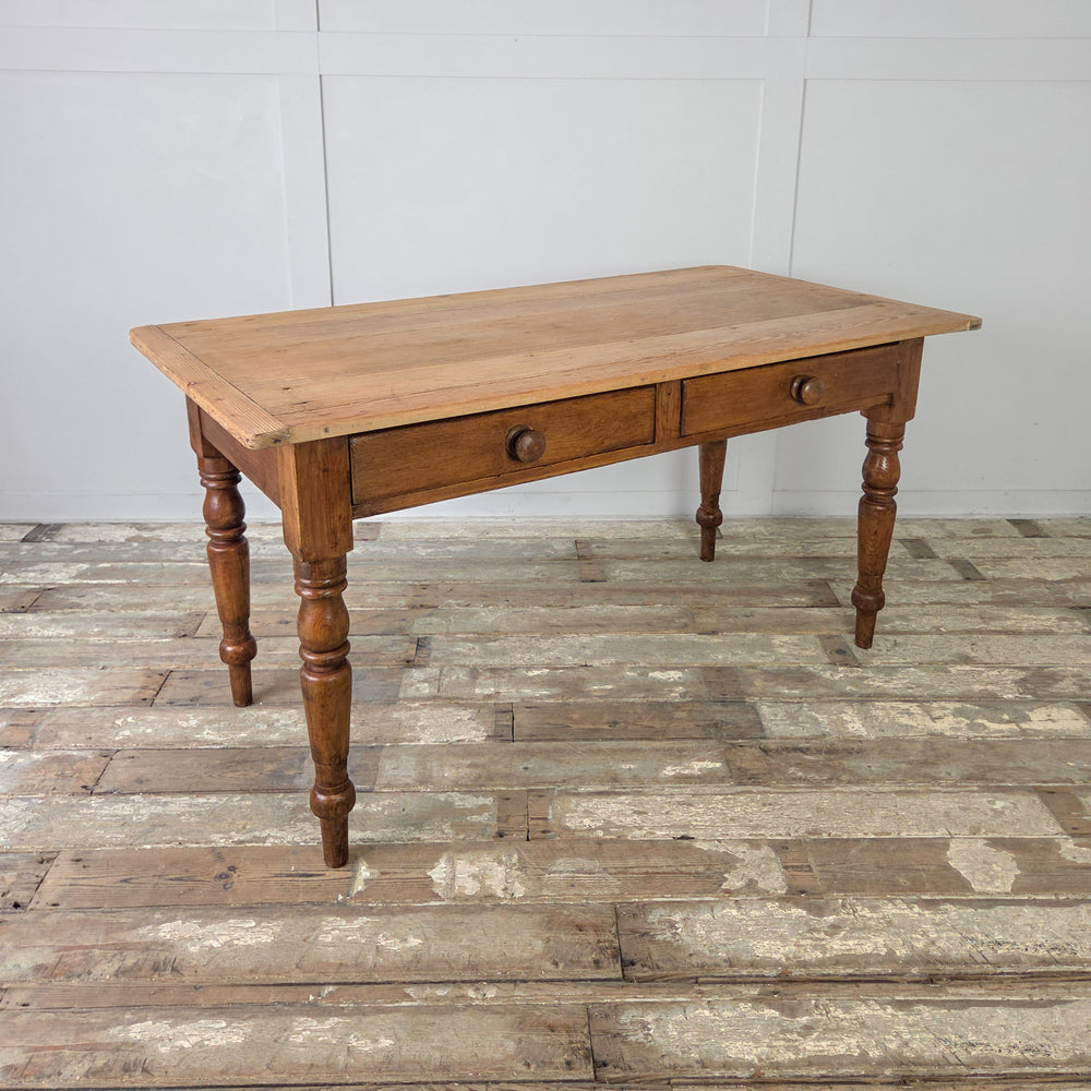 Antique Victorian pine farmhouse table, classic 19th century design, kitchen prep table with characterful patina, two storage drawers, and decorative turned legs.
