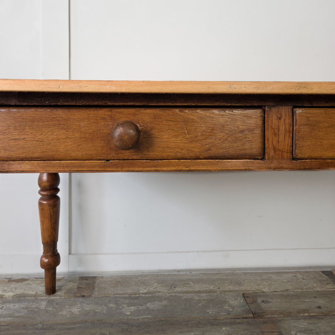 Victorian pine table, original wooden knobs, turned legs, and two practical drawers, antique farmhouse piece for kitchens or dining rooms.

