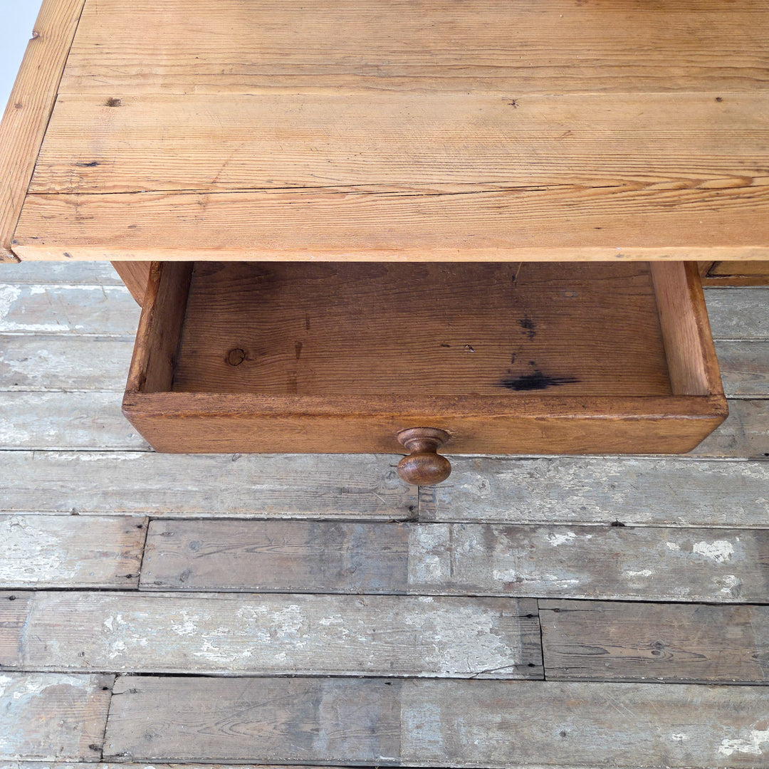 Antique pine farmhouse table, 19th century English origin, solid construction with decorative legs and drawers, suited to kitchen, living, or office spaces.
