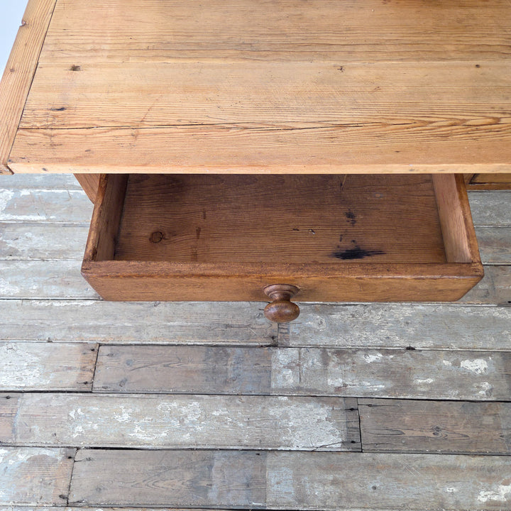 Antique pine farmhouse table, 19th century English origin, solid construction with decorative legs and drawers, suited to kitchen, living, or office spaces.
