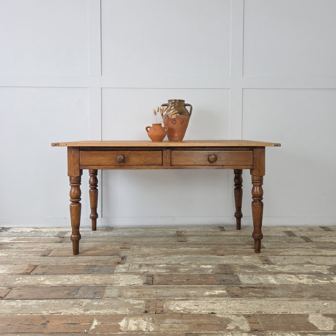 Victorian pine kitchen prep table with turned legs and two drawers, 19th century farmhouse style, antique pine table with traditional details and original wooden knobs.
