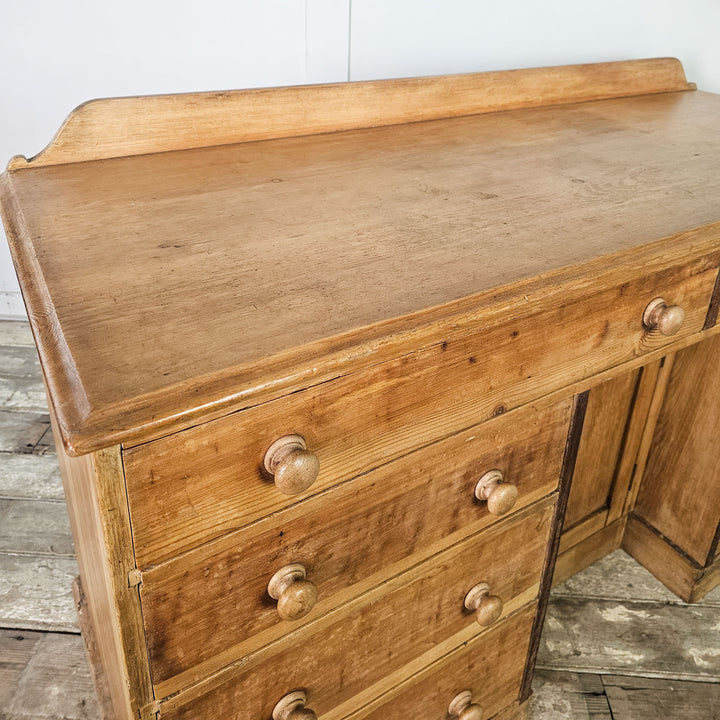 Pine sideboard with eight drawers, ideal for home organization.

