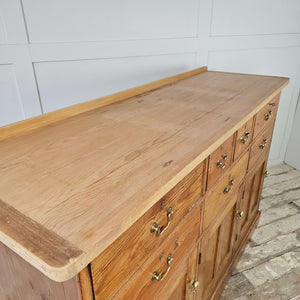 Large pine dresser suitable for storing utensils and crockery.
