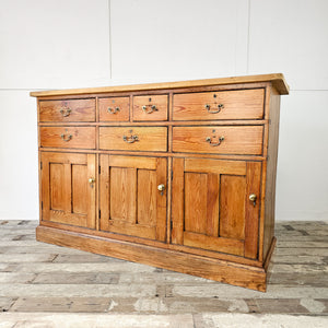 19th-century pine dresser with seven drawers and three cupboards.