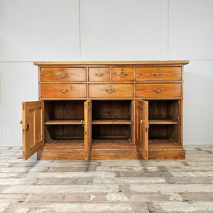 Antique pine sideboard with seven drawers.
