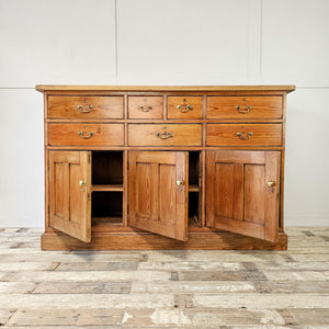 Country pine dresser with brass handles.
