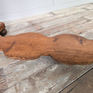 A farmhouse-style Victorian pine washstand with a shaped gallery back, two drawers fitted with brass swan neck handles and a lower shelf. The pine is sealed with antique wax and the piece rests on shaped supports with ball feet.