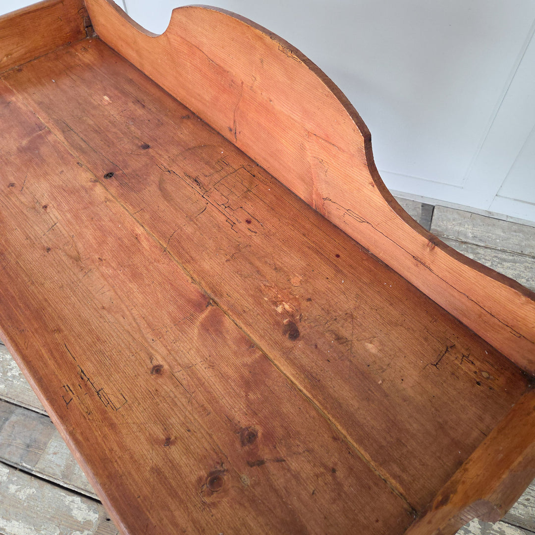 Victorian antique pine washstand, finished in wax polish to protect the surface and highlight the natural patina. Features include a scroll-sided gallery back, shaped lower shelf and turned legs, making it ideal for farmhouse style interiors as a console or rustic side table.