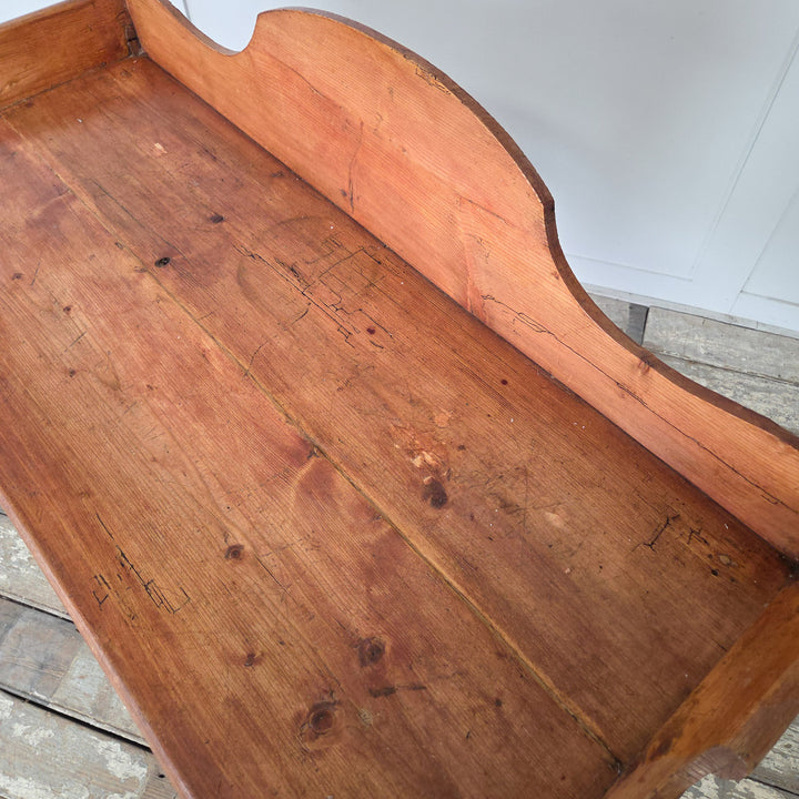 Victorian antique pine washstand, finished in wax polish to protect the surface and highlight the natural patina. Features include a scroll-sided gallery back, shaped lower shelf and turned legs, making it ideal for farmhouse style interiors as a console or rustic side table.