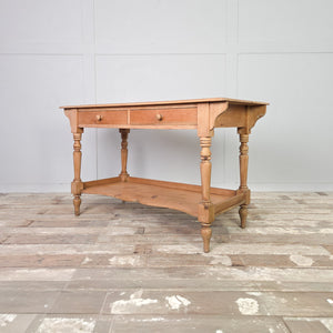 Victorian antique pine washstand dating to the 19th century, featuring two wooden-knob drawers, a shaped lower shelf and four turned legs. The light pine patina has been protected with clear wax. A country farmhouse piece for use as a hall table, console table or dressing table.