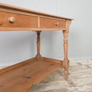 Antique Victorian pine washstand from the 19th century with two drawers fitted with wooden knobs, supported on turned legs with a shaped lower shelf. Finished in a clear wax over a light pine patina. A country farmhouse piece suited to console table, hall table or dressing table use.