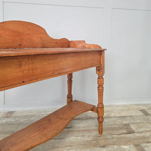 Victorian antique pine washstand in waxed pine, featuring scroll-sided gallery back, turned legs and shaped lower shelf. Ideal for farmhouse interiors, this 19th century piece doubles as a rustic console or side table, adding antique character to hallways, bedrooms or living spaces.