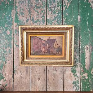 Antique 19th century painting in oil, depicting a calm countryside setting with a rustic building and softly painted sky. Framed in ornate gilt, this Victorian artwork is a beautiful historic addition to any vintage or period-inspired room.