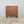 Antique pine chest of drawers with original buttermilk painted finish, raised on four dark contrasting bun feet